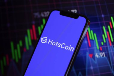 KYIV, UKRAINE - MARCH 15, 2024 Hotscoin logo on iPhone display screen and crypto currency value charts. Cryptocurrency exchange portal clipart