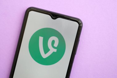 KYIV, UKRAINE - 1 Nisan 2024 Vine simgesi mor masadaki akıllı telefon ekranında. Leylak arka planında uygulama logosu olan iPhone görüntüsü