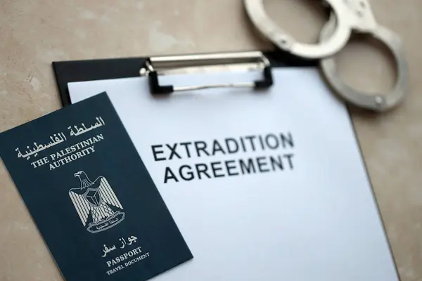 stock image Passport of Palestinian Authority and Extradition Agreement with handcuffs on table close up