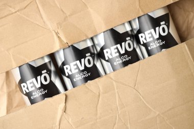 KYIV, UKRAINE - APRIL 20, 2024 Cans of Revo alco energy drink in new design with logo in black star close up clipart