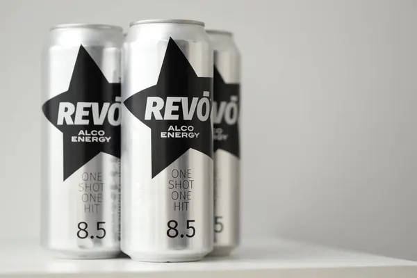 stock image KYIV, UKRAINE - APRIL 20, 2024 Cans of Revo alco energy drink in new design with logo in black star close up