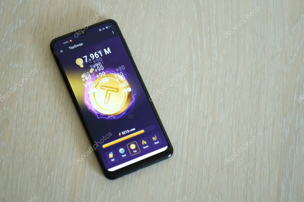 KYIV, UKRAINE - APRIL 20, 2024 Tap Swap telegram bot on smartphone screen. Tap Swap is a viral Telegram based crypto game for earn tokens by managing a virtual crypto exchange