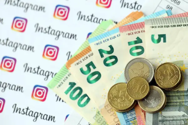 KYIV, UKRAINE - 20 Nisan 2024 Instagram logosu ve çok sayıda euro para faturası. Ünlü sosyal ağ platformu ve Avrupa para birimi banknotlarının sembolü