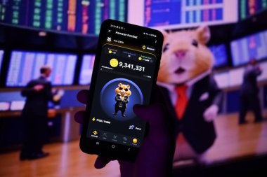 KYIV, UKRAINE - APRIL 20, 2024 Hamster Kombat telegram bot on smartphone screen. Hamster Kombat is a viral Telegram-based crypto game for earn HMSTR tokens by managing a virtual crypto exchange clipart