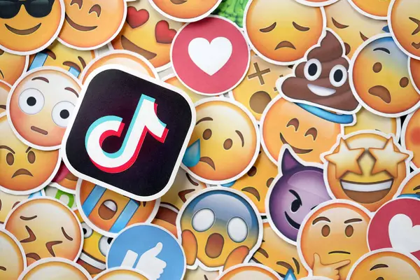 stock image KYIV, UKRAINE - APRIL 20, 2024 TikTok logo and large set of stickers with Emoji yellow faces. Emoji is a pictogram or smiley embedded in text and used in electronic messages and web pages