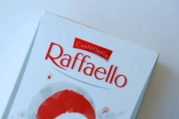 Stock image KYIV, UKRAINE - APRIL 20, 2024 Ferrero Raffaello premium sweets produced by the Italian chocolatier Ferrero SpA on a white background. Raffaello candies is a spherical coconut almond confection