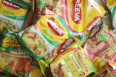 KYIV, UKRAINE - APRIL 20, 2024 Many packs of instant noodles for fast cooking by various brands and manufacturers close up clipart