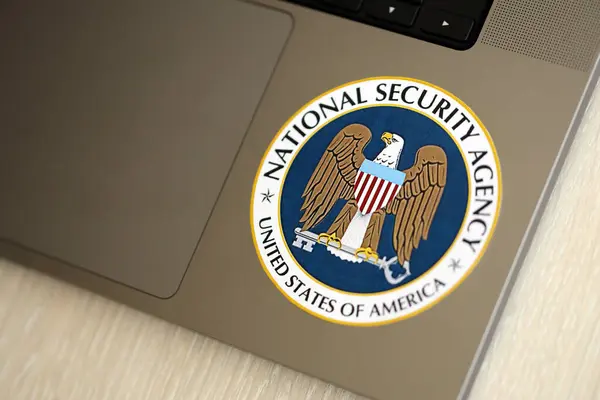 stock image KYIV, UKRAINE - JUNE 26, 2024 United States of America National Security Agency coat of arms sticker on silver laptop close up