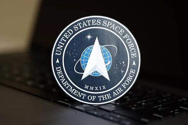 stock image KYIV, UKRAINE - JUNE 26, 2024 United States Space Force Department of the Air Force coat of arms sticker on silver laptop close up