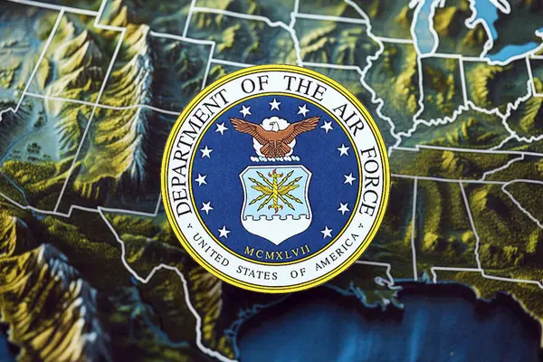 Stock image KYIV, UKRAINE - JUNE 26, 2024 United States Department of the Air Force coat of arms on paper map of United States of America