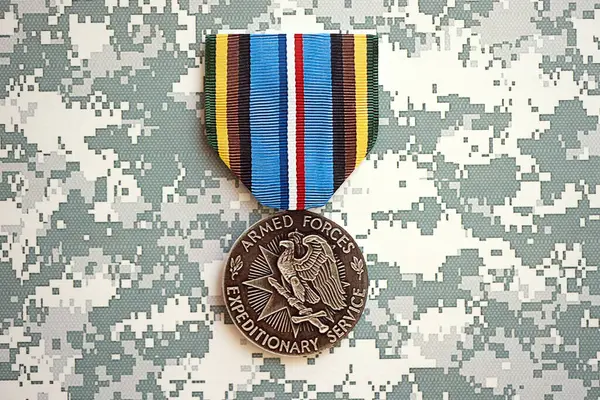 stock image KYIV, UKRAINE - JULY 10, 2024 US Armed Forces Expeditionary medal. United States military award medal with ribbon and pin. Handmade paper theater props close up