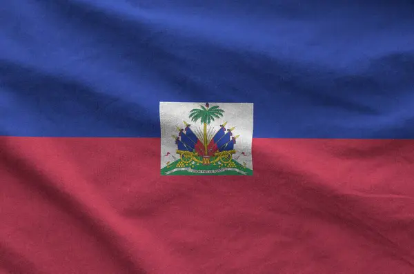 stock image Haiti flag depicted on folded wavy fabric of old cloth close up