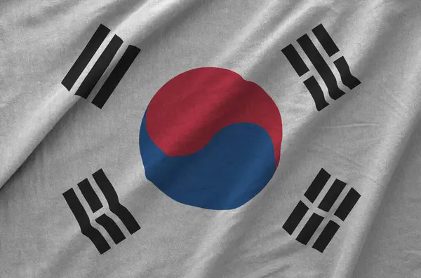 Stock image South Korea flag depicted on folded wavy fabric of old cloth close up