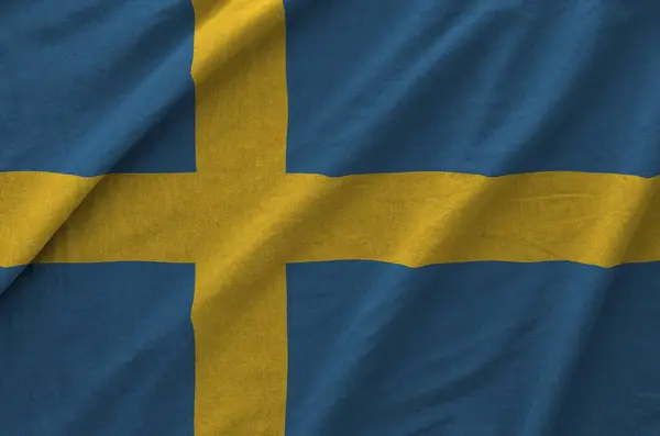 stock image Sweden flag depicted on folded wavy fabric of old cloth close up