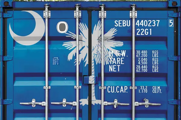 stock image South Carolina US state flag depicted on metal doors of shipping cargo container outdoors in docks area close up