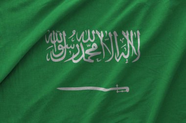 Suudi Arabistan bayrağı eski kumaşların katlanmış dalgalı kumaşında tasvir edilmiştir.