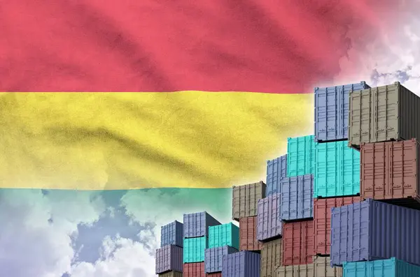 stock image Bolivia flag and big stack of shipping cargo containers in docks with sky background close up