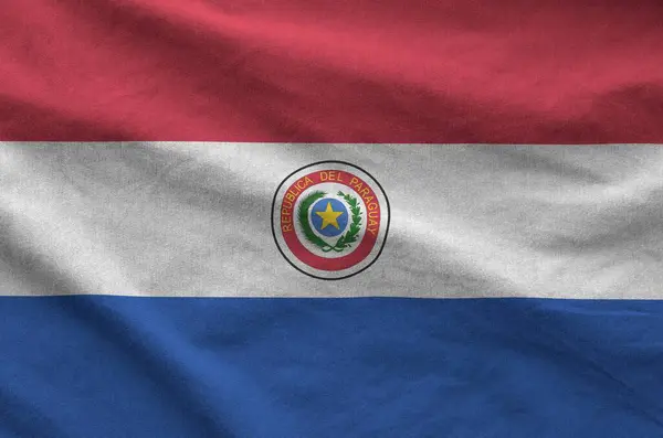 stock image Paraguay flag depicted on folded wavy fabric of old cloth close up