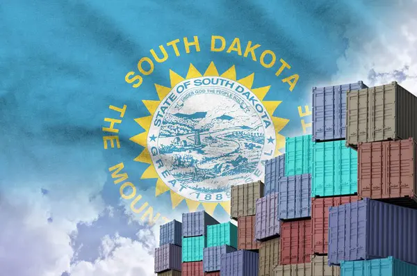 stock image South Dakota US state flag and big stack of shipping cargo containers in docks with sky background close up