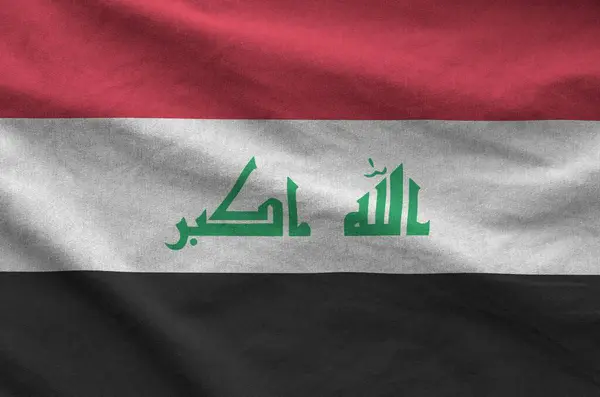 stock image Iraq flag depicted on folded wavy fabric of old cloth close up