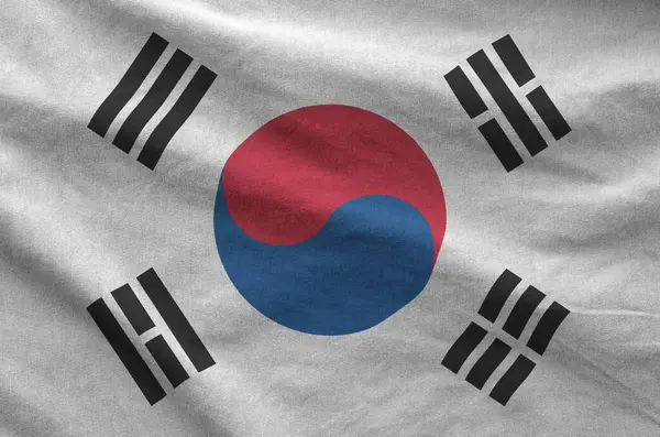 stock image South Korea flag depicted on folded wavy fabric of old cloth close up