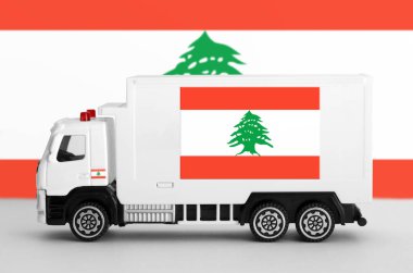 Lebanon flag depicted on side wall of white delivery van close up. Shipping and local delivery concept clipart