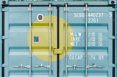 Palau flag depicted on metal doors of shipping cargo container outdoors in docks area close up clipart