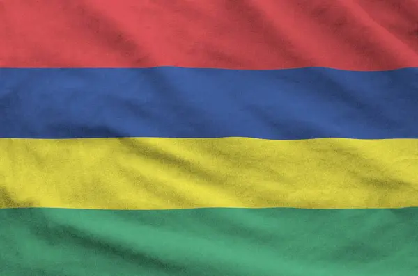 stock image Mauritius flag depicted on folded wavy fabric of old cloth close up