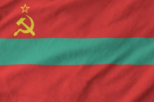 stock image Transnistria flag depicted on folded wavy fabric of old cloth close up