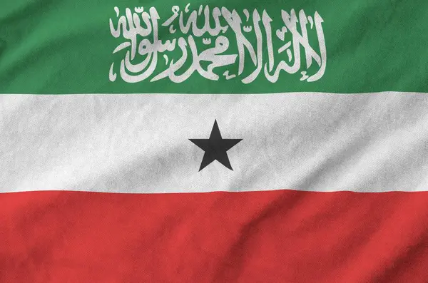 stock image Somaliland flag depicted on folded wavy fabric of old cloth close up