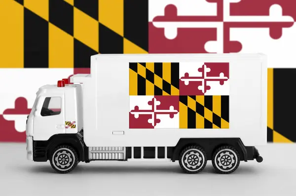 stock image Maryland US state flag depicted on side wall of white delivery van close up. Shipping and local delivery concept