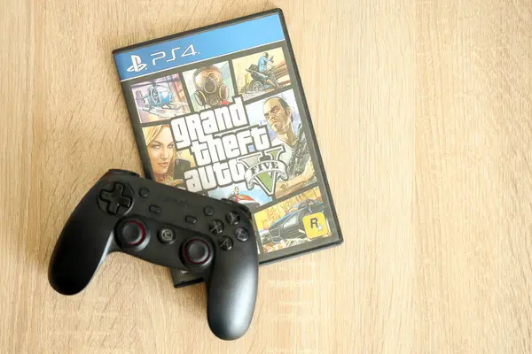 stock image KYIV, UKRAINE - JUNE 26, 2024 Grand Theft Auto 5 PS4 video game disc box for console gaming. Popular video game disc close up