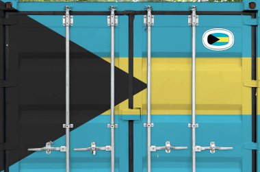 Bahamas flag depicted on metal doors of shipping cargo container outdoors in docks area close up clipart