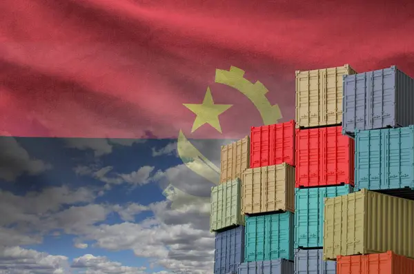 Stock image Angola flag and big stack of shipping cargo containers in docks with sky background close up