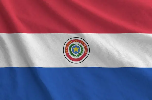 Stock image Paraguay flag depicted on folded wavy fabric of old cloth close up