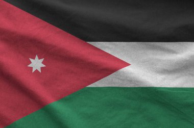 Jordan flag depicted on folded wavy fabric of old cloth close up clipart