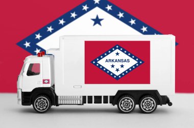 Arkansas US state flag depicted on side wall of white delivery van close up. Shipping and local delivery concept clipart