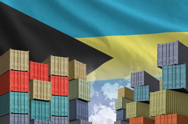 stock image Bahamas flag and big stack of shipping cargo containers in docks with sky background close up