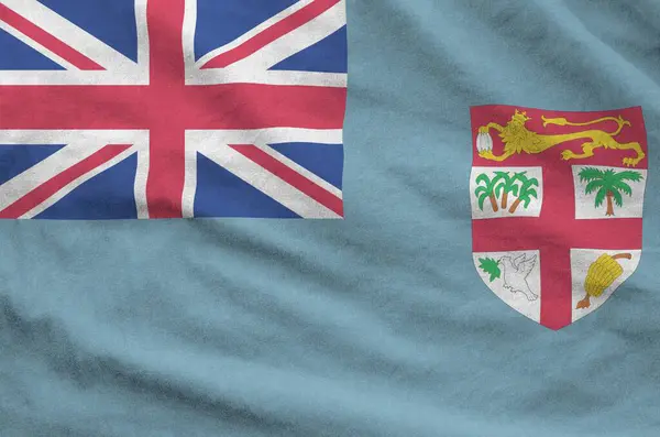 stock image Fiji flag depicted on folded wavy fabric of old cloth close up