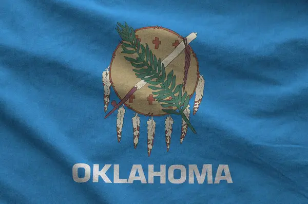 stock image Oklahoma US state flag depicted on folded wavy fabric of old cloth close up