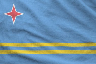 Aruba flag depicted on folded wavy fabric of old cloth close up clipart