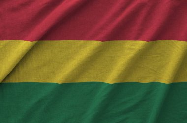 Bolivia flag depicted on folded wavy fabric of old cloth close up clipart