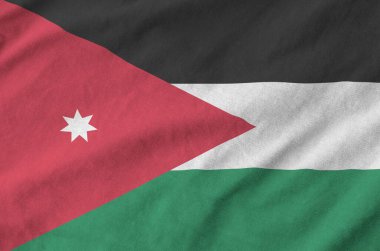 Jordan flag depicted on folded wavy fabric of old cloth close up clipart