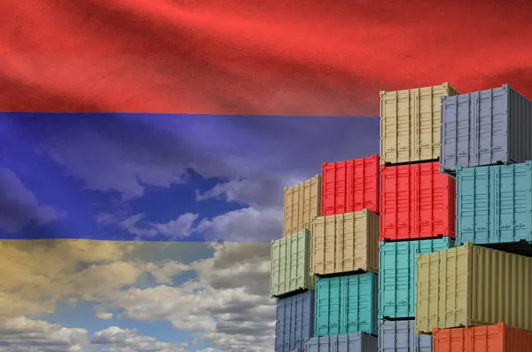 stock image Armenia flag and big stack of shipping cargo containers in docks with sky background close up