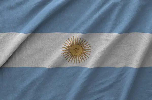 stock image Argentina flag depicted on folded wavy fabric of old cloth close up