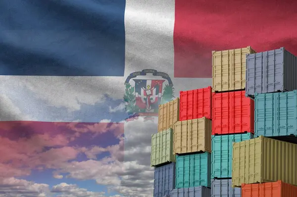 stock image Dominican Republic flag and big stack of shipping cargo containers in docks with sky background close up