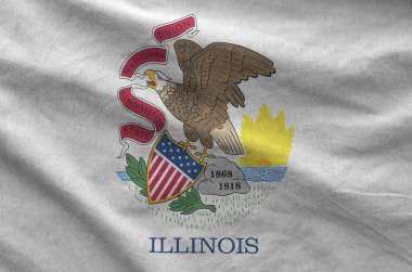 Illinois US state flag depicted on folded wavy fabric of old cloth close up clipart