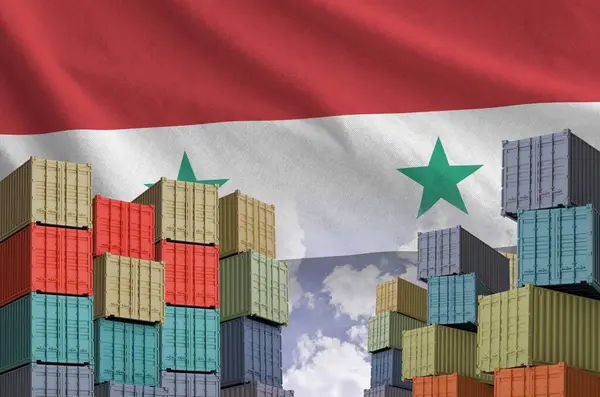 stock image Syria flag and big stack of shipping cargo containers in docks with sky background close up