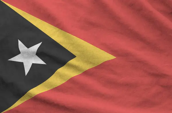 stock image Timor Leste flag depicted on folded wavy fabric of old cloth close up