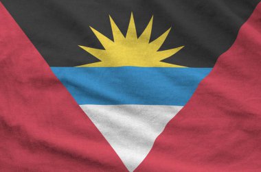 Antigua and Barbuda flag depicted on folded wavy fabric of old cloth close up clipart